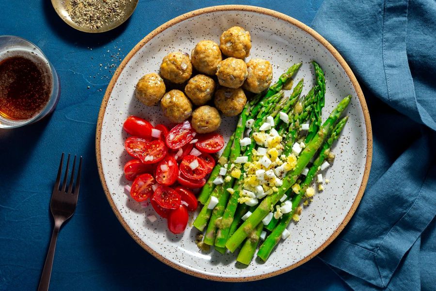 Meatballs with tomato salad and asparagus mimosa