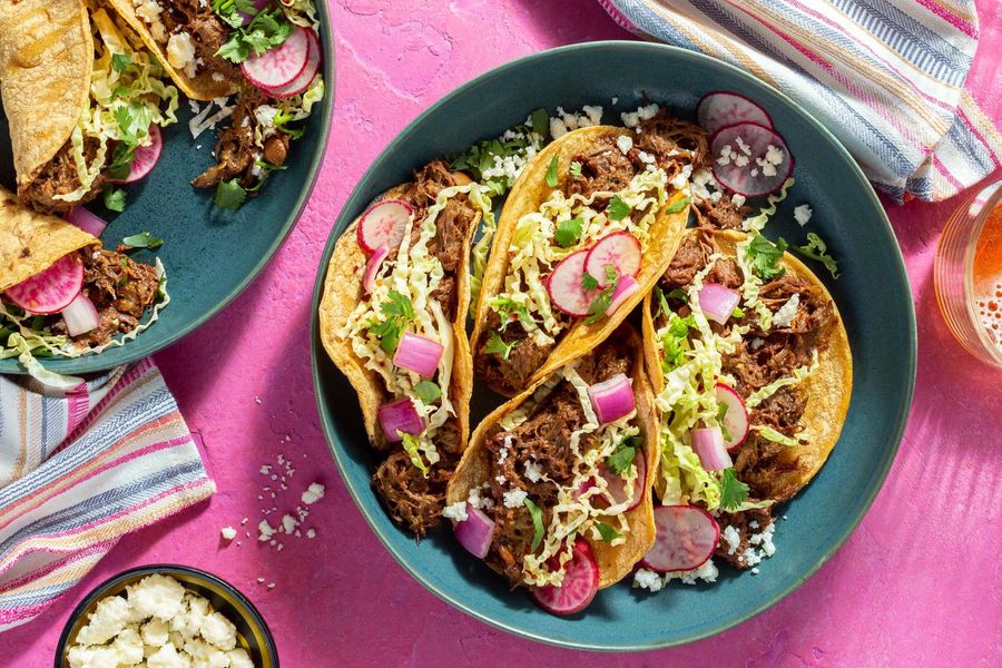 Spicy duck mole tacos with cabbage-radish slaw and queso fresco