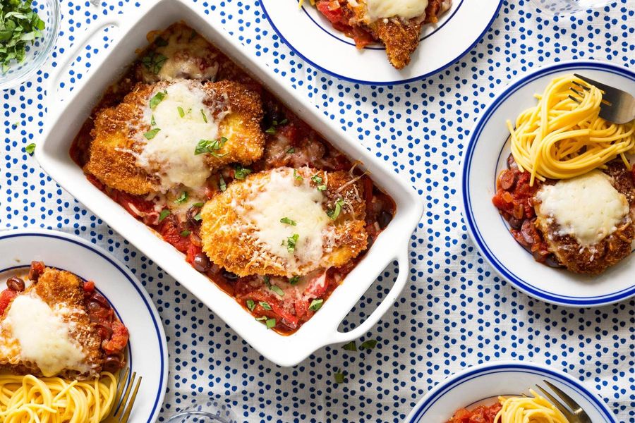Chicken Parmesan with tomato-olive sauce and whole wheat spaghetti