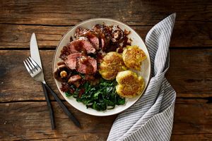 Steaks with peppercorn sauce, smashed potatoes, and spinach
