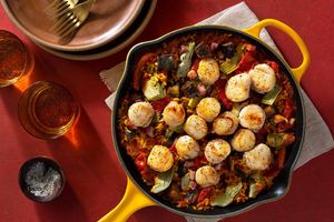 Seared sea scallops over pancetta, eggplant, and artichoke paella