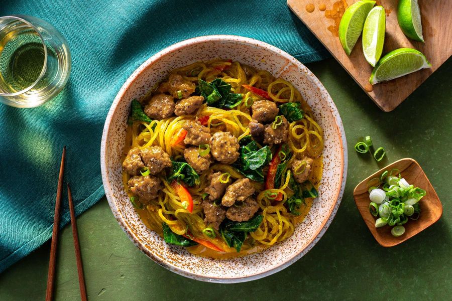 Curry noodle bowls with broccoli leaves and bell pepper