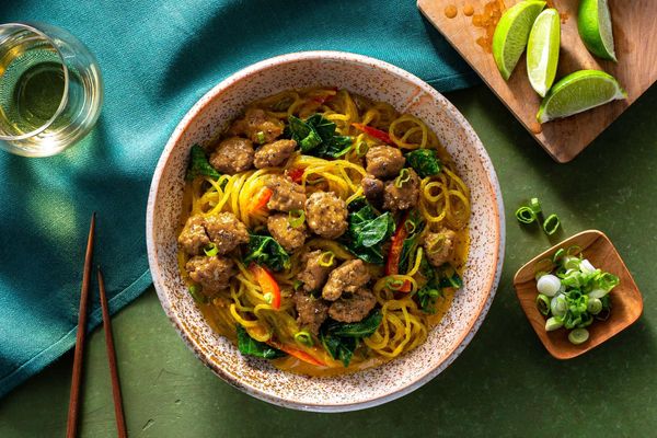 Chicken curry noodle bowls with broccoli leaves and bell pepper