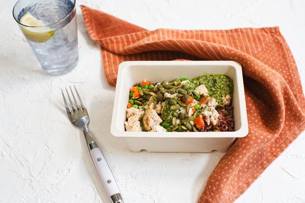 Chicken mole verde with red rice, sweet peas, and pumpkin seeds