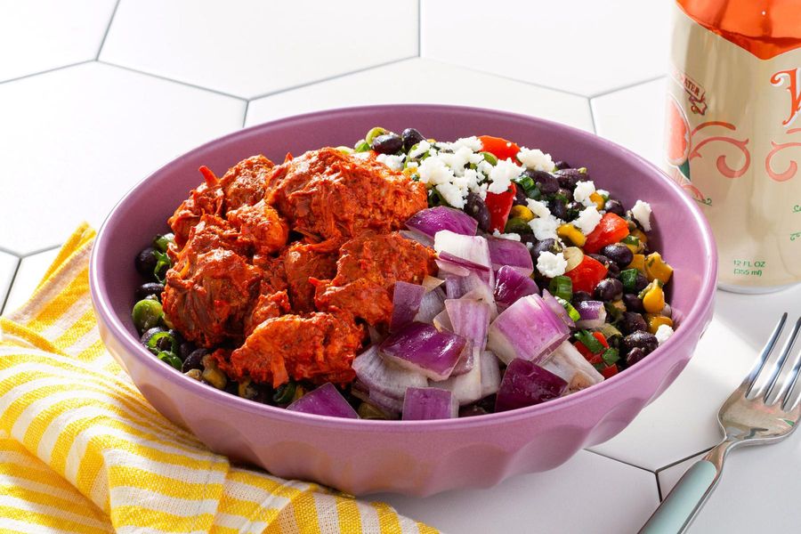 Burrito bowl with achiote-citrus braised pork, corn, and black beans