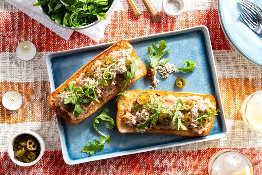 Pulled pork tartines with white bean spread and arugula