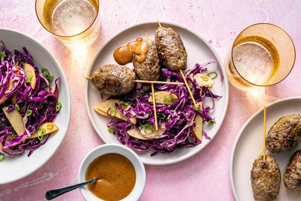 Ginger-scallion beef skewers with apple and cabbage slaw