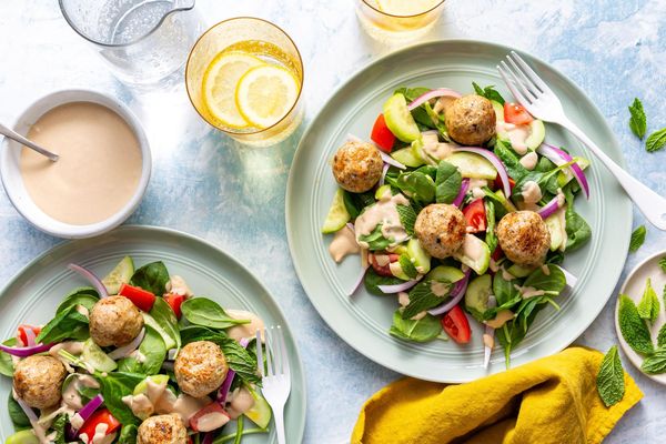 Greek meatballs with tomato-cucumber salad and lemon-tahini dressing