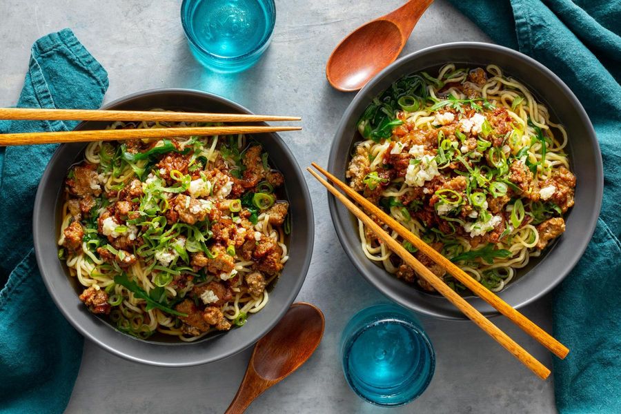 Taiwanese noodle soup with baby greens and your choice of protein
