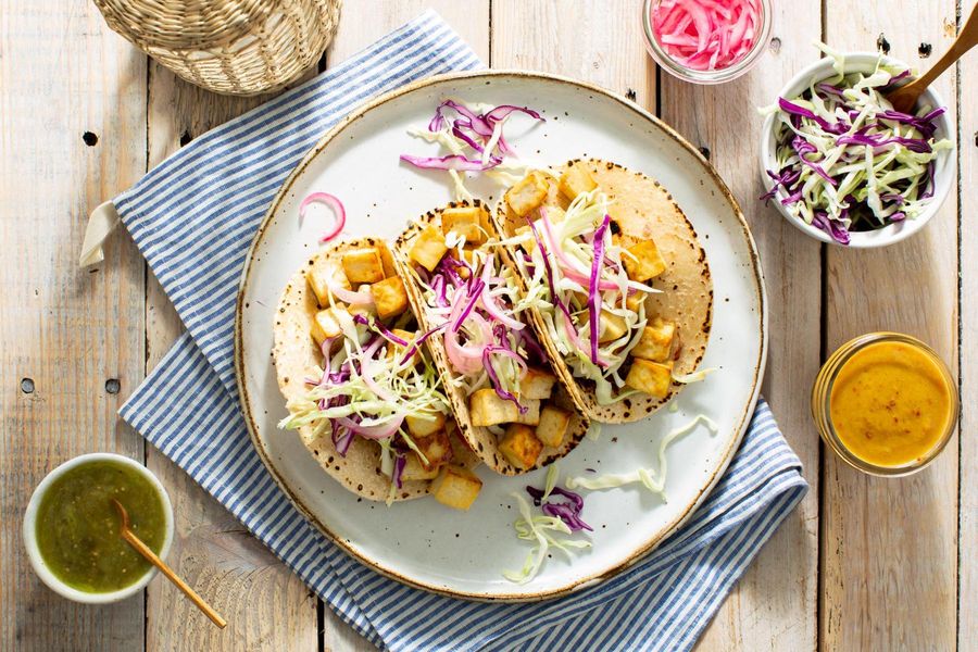 Mojo tacos with shredded cabbage, pickled onions, and salsa verde