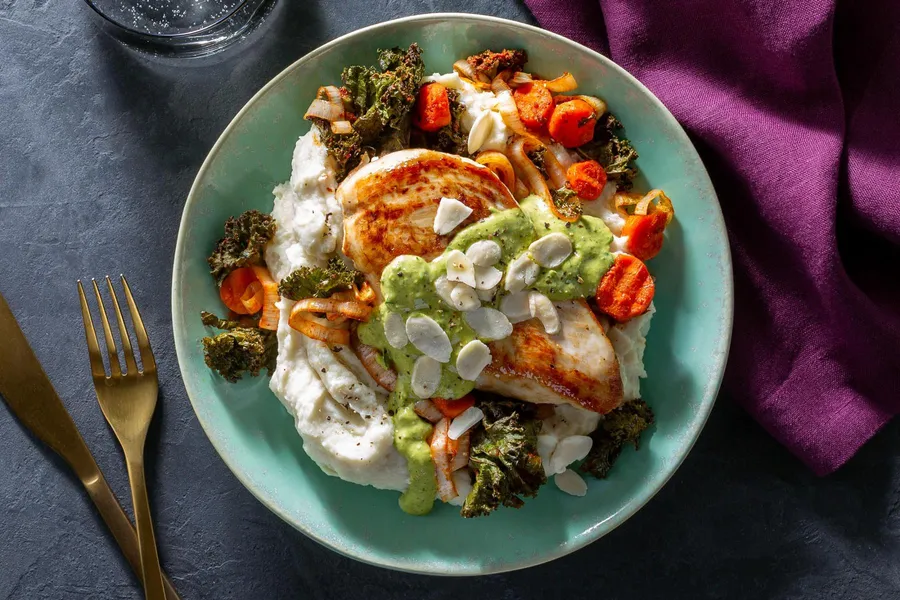 Roast chicken with harissa-spiced veggies, cauli mash, and almonds