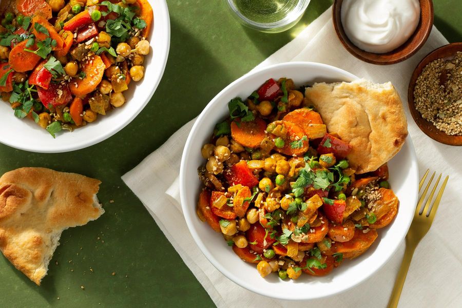 Bengali-style curried vegetables with chickpeas, lime yogurt, and naan