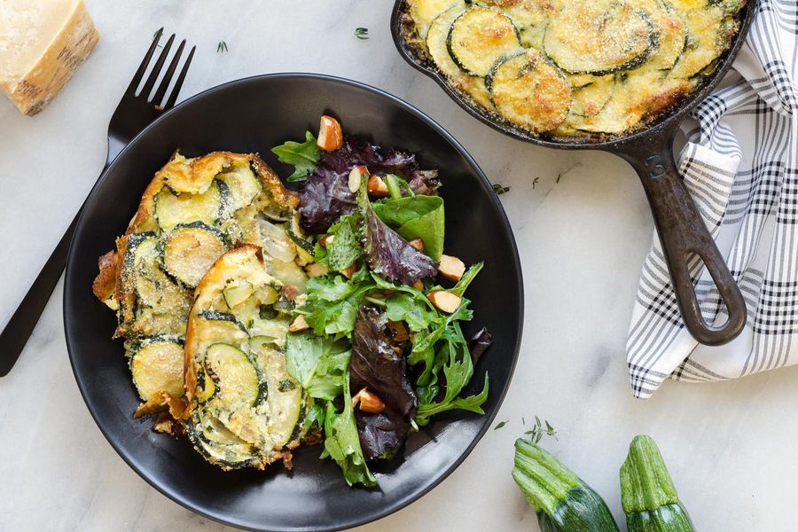 Zucchini and ricotta torta with mixed greens