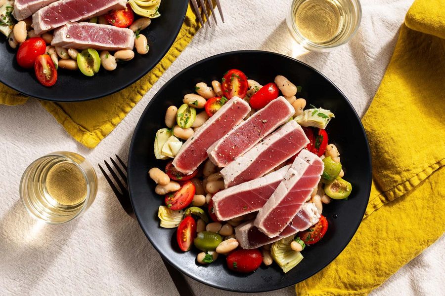 Yellowfin tuna poached with lemon and rosemary over white bean salad