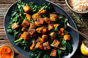 Blackened tempeh over Cajun rice and greens