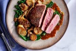 Black Angus steaks with Dijon glaze, Lyonnaise potatoes, and wilted spinach