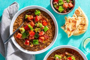 Ethiopian red lentil stew with berbere, tomato salad, and toasted naan