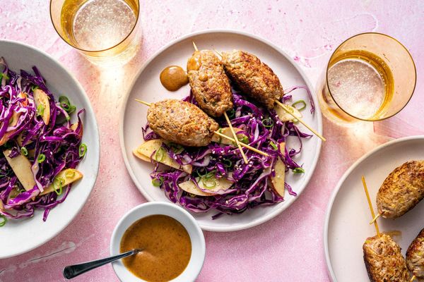 Ginger-scallion beef skewers with apple and cabbage slaw