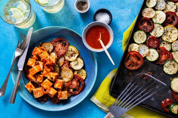 Tomato-braised pollock over roasted zucchini and new potatoes