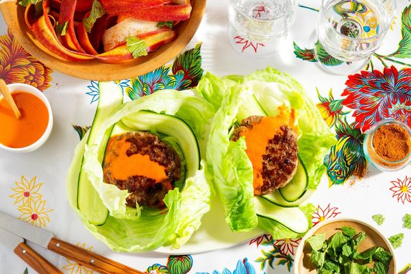Lettuce-wrapped turkey burgers with spicy chraime carrot salad