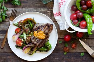Steaks with paprika butter, pan-charred vegetables, and gremolata