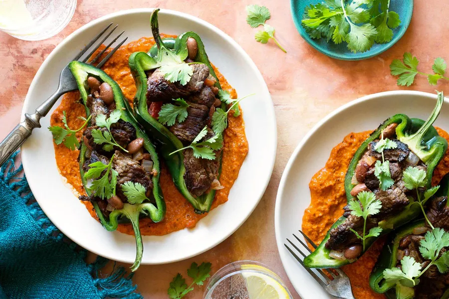 Chiles rellenos with sirloin steak strips, pinto beans, and romesco