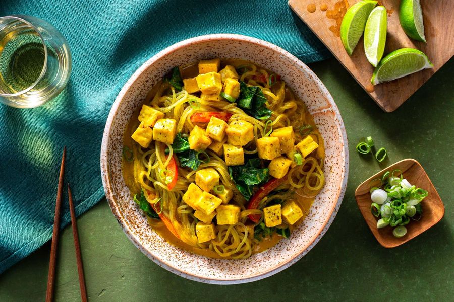 Curry noodle bowls with broccoli leaves and bell pepper