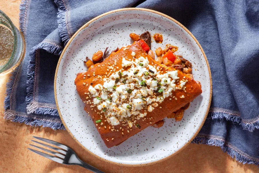 Beef mole enchilada pie with pinto beans and queso fresco