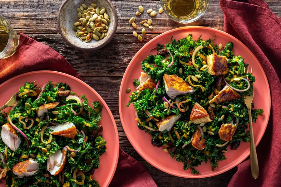 Curried salmon and kale salad with warm carrot-ginger vinaigrette