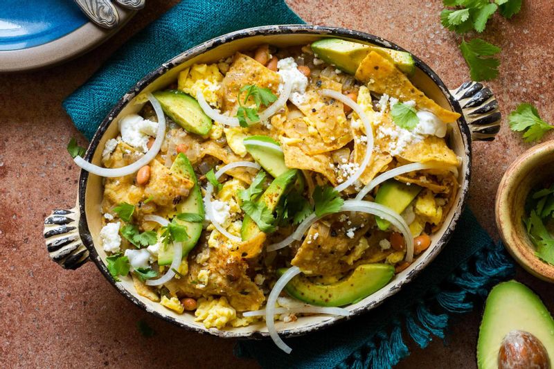 Chilaquiles verdes with soft-scrambled eggs, avocado, and queso fresco ...