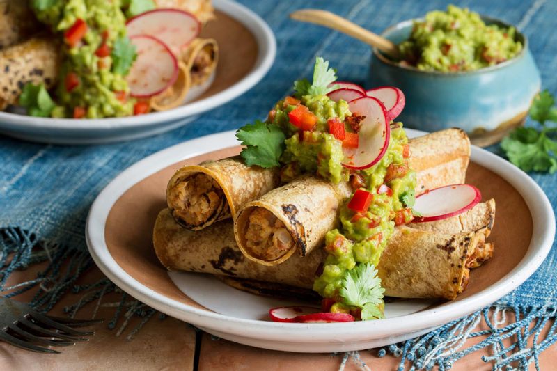 Pinto bean and cauliflower taquitos with radish salad and guacamole