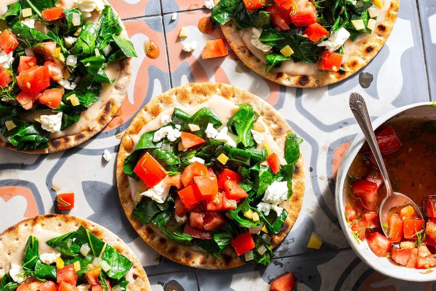 Istanbul flatbreads with wilted greens, feta, and preserved lemon