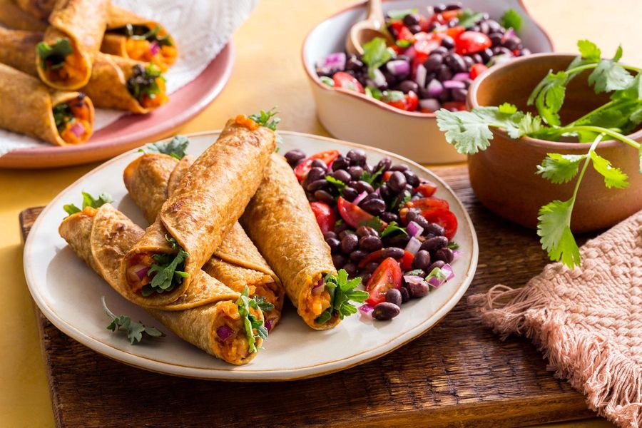 Sweet potato and kale taquitos with black bean salad