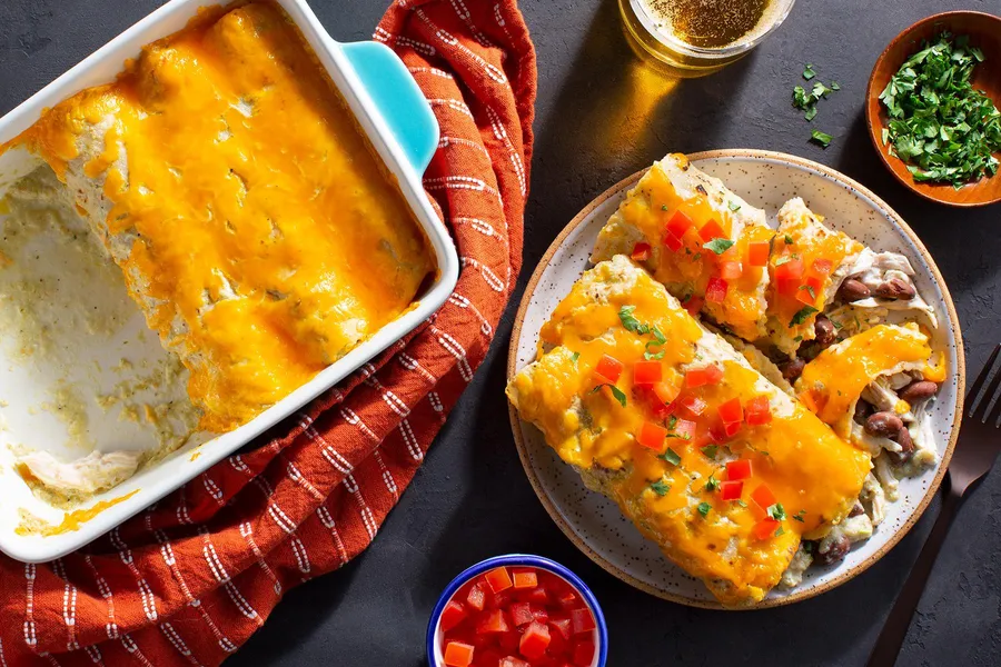 Chicken enchiladas with pinto beans and creamy tomatillo sauce