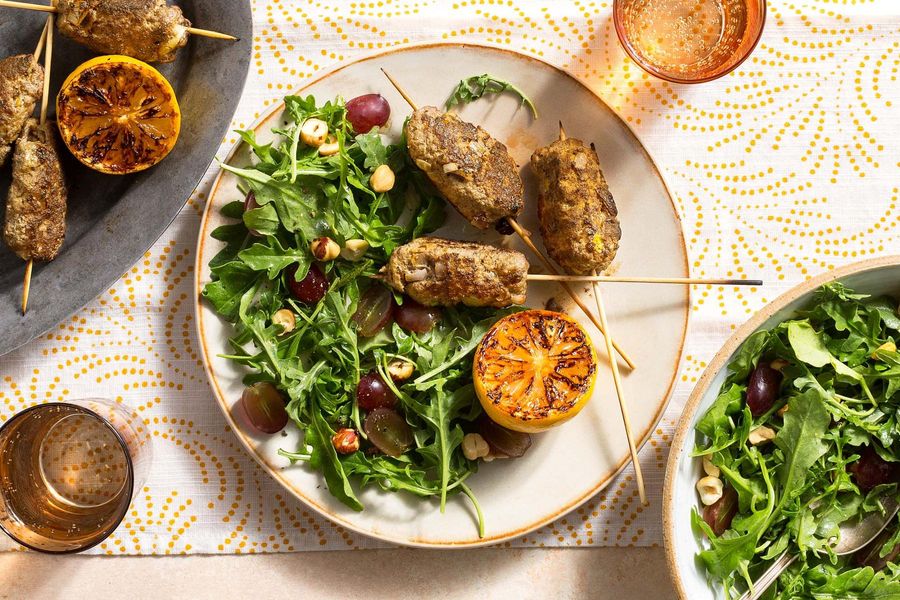 Greek souzoukaklia skewers with arugula-grape salad