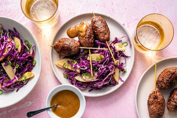 Ginger-scallion beef skewers with apple and cabbage slaw