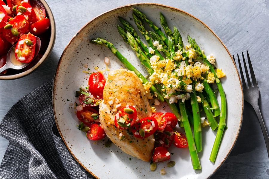 Seared chicken breasts with tomato salsa, asparagus, and chopped eggs