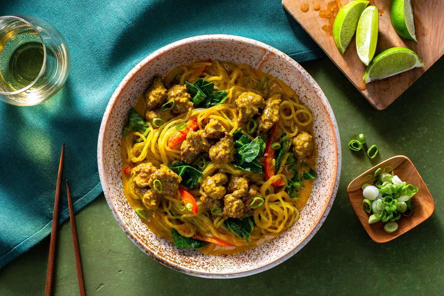 Curry noodle bowls with broccoli leaves and bell pepper