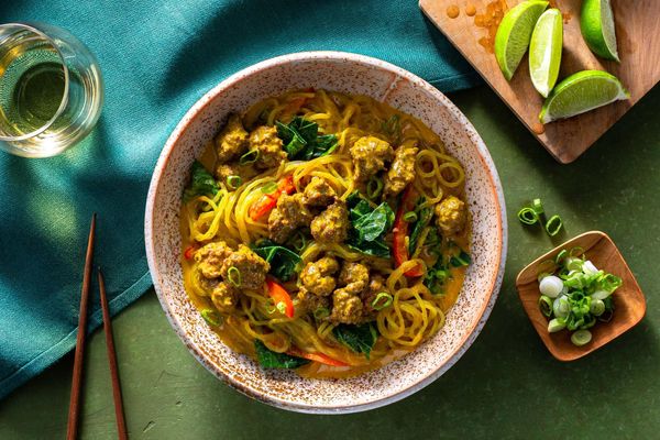 Chicken curry noodle bowls with broccoli leaves and bell pepper