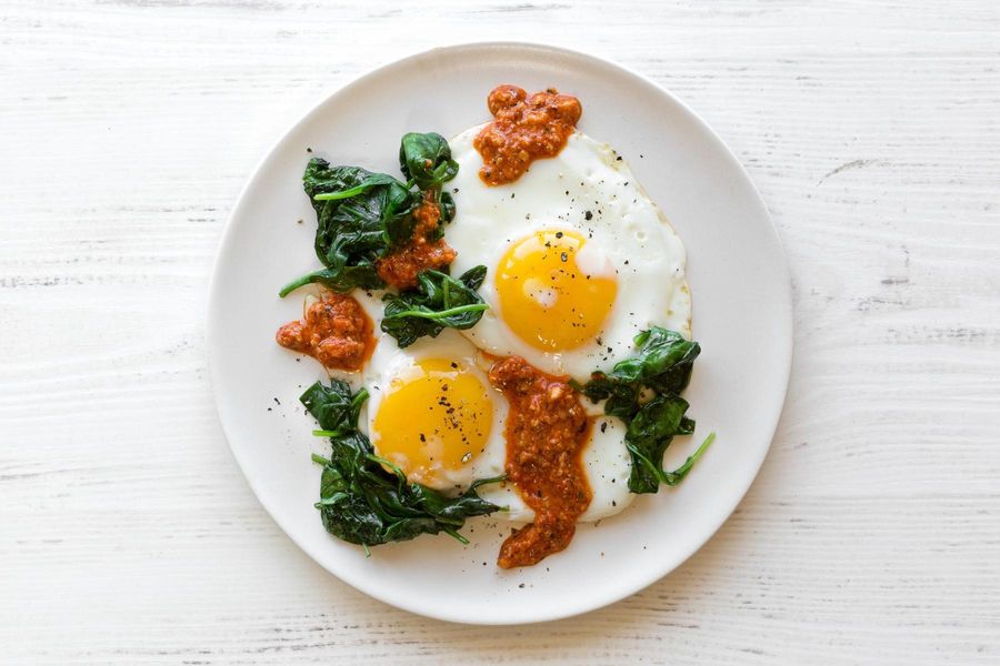 Fried eggs with spinach and romesco
