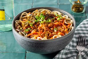 Korean-inspired ramen bowl with spicy pork, carrots, and cabbage