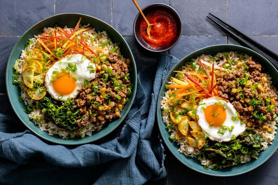 Korean beef bibimbap with spinach, squash, and fried eggs