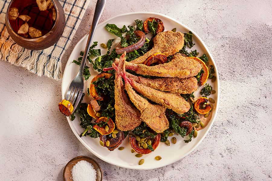 Cornmeal-crusted lamb chops and roasted delicata squash over kale salad