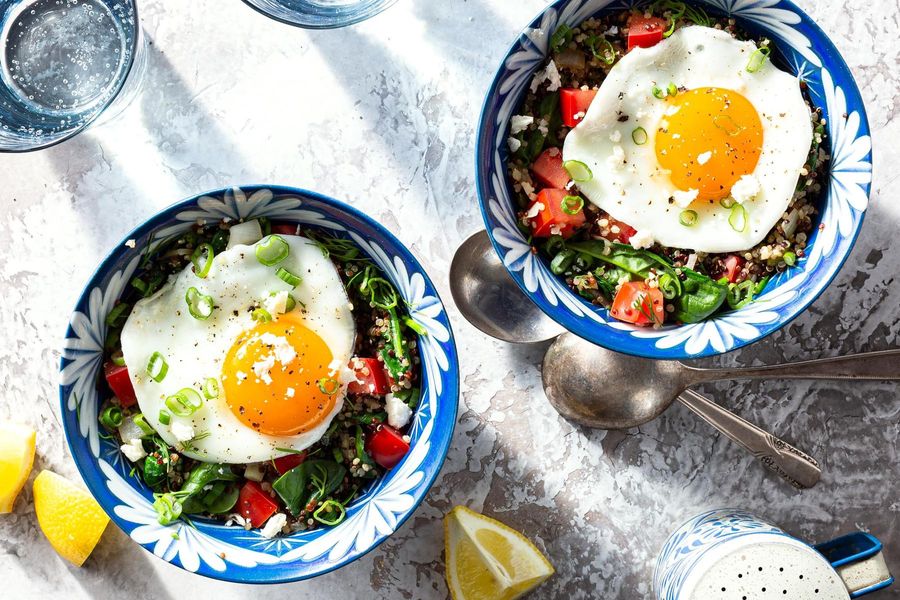 Quinoa-spinach grain bowls with feta, fried eggs, and fresh dill