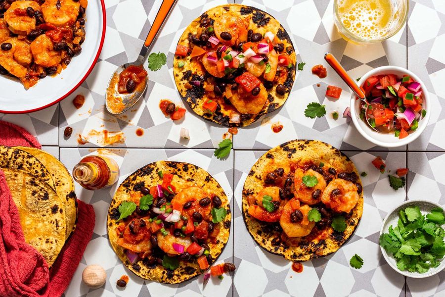 Spicy tinga tacos with black beans and pico de gallo