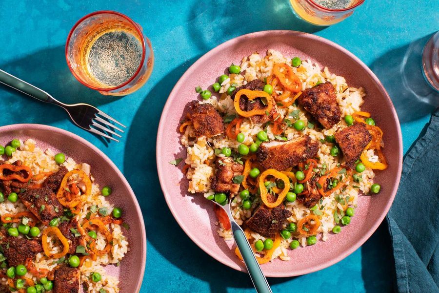 Puerto Rican arroz con pollo with mini peppers and sweet peas