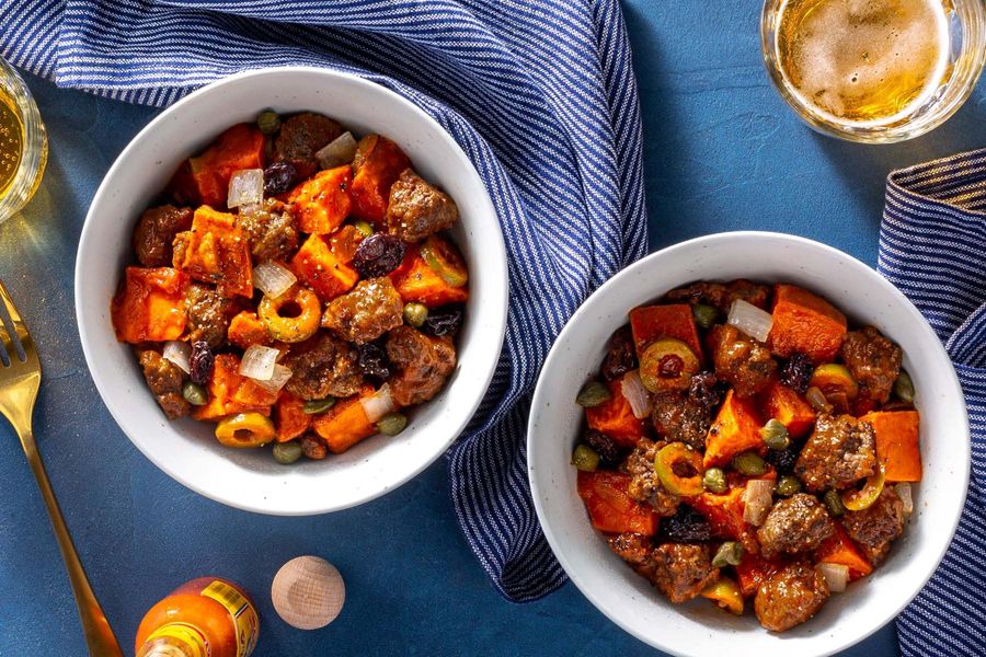 Picadillo stew with capers and raisins over roasted sweet potato