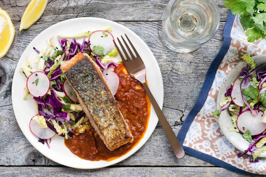 Seared salmon in charaimeh sauce with cabbage slaw