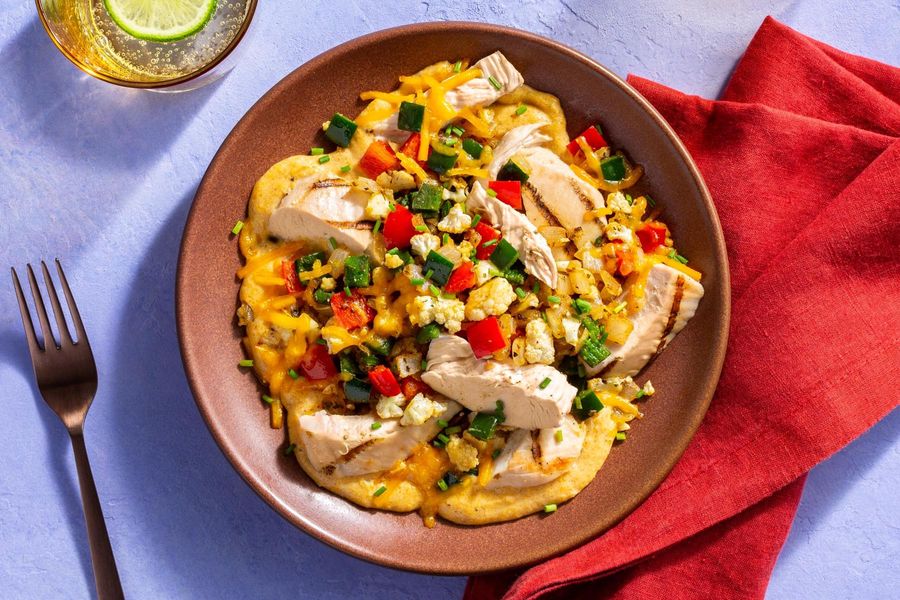 Grilled fajita chicken and vegetables with chili-spiced cheese sauce