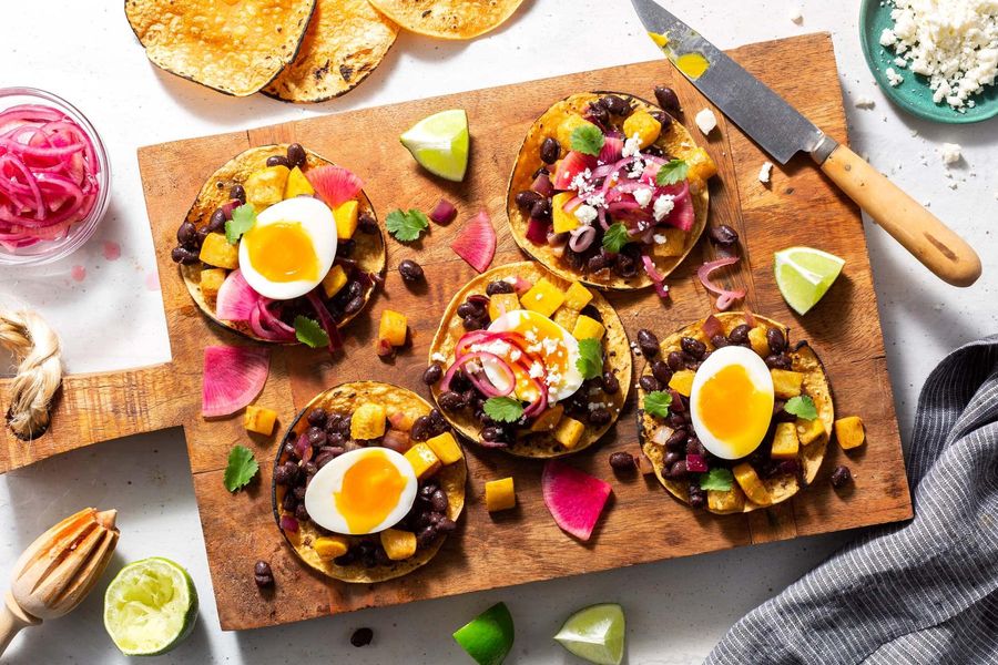 Black bean tostadas with yellow squash and soft-cooked eggs